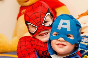 Children wearing Spiderman and Captain America costumes